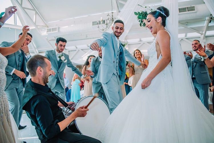 Live drum performance with bride and groom